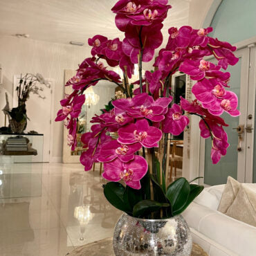 orquídeas en craquelado espejo jarrón